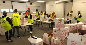 Volunteers packaging Reverse Advent Calendar boxes.