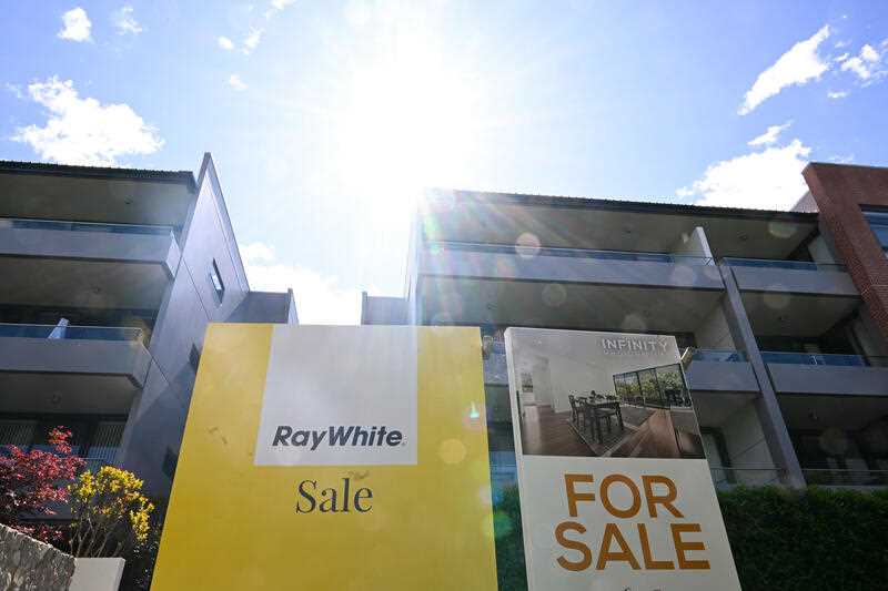‘For Sale’ signs are seen near apartment blocks in Canberra